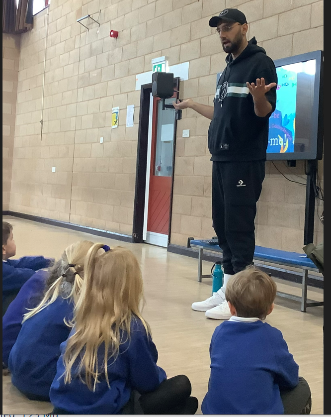 Image of author talking to pupils